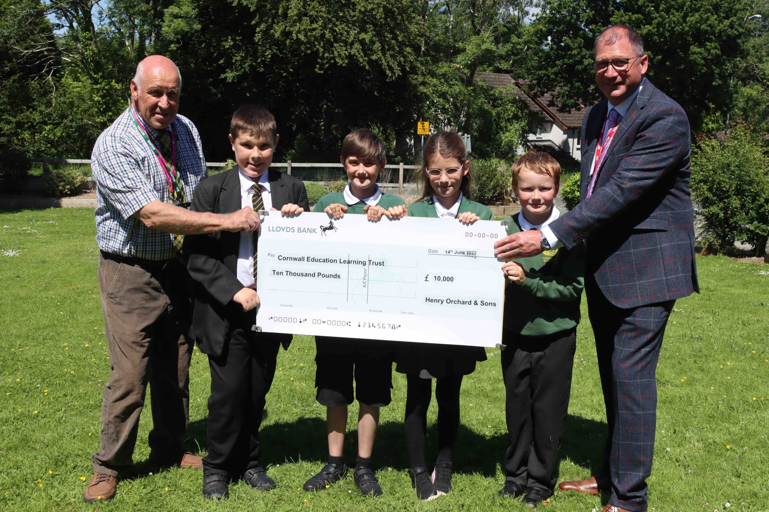 Cheque presentation featuring L-R: Geoff Brown (Chair of Trust Board at Cornwall Education Learning Trust), Finlay (Penrice Academy), Oliver + Flora + Ewan (Luxulyan School), Henry Orchard.