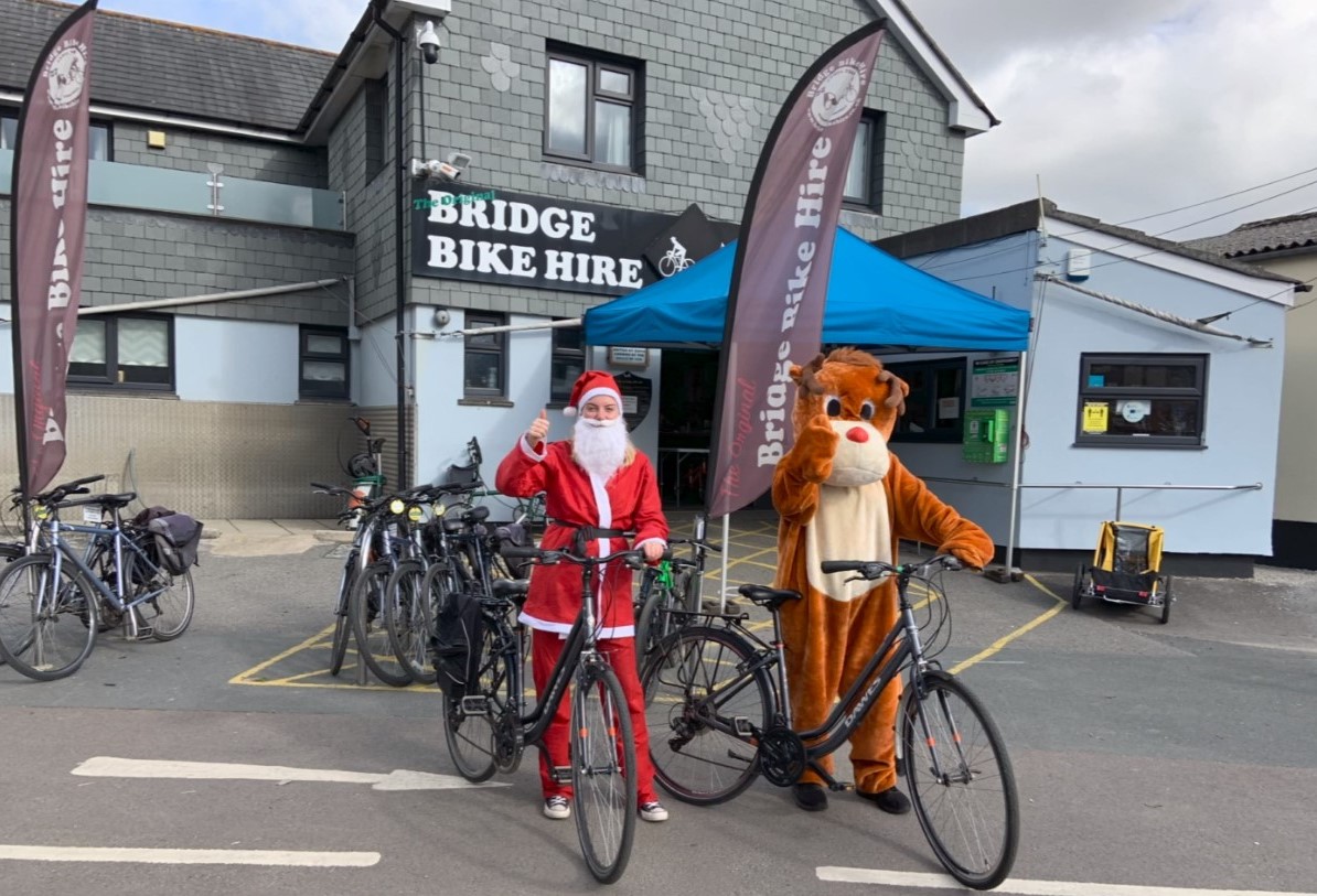 Santa and Rudolph (dressed up) ready to set off on their bikes from Bridge Bike Hire in Wadebridge